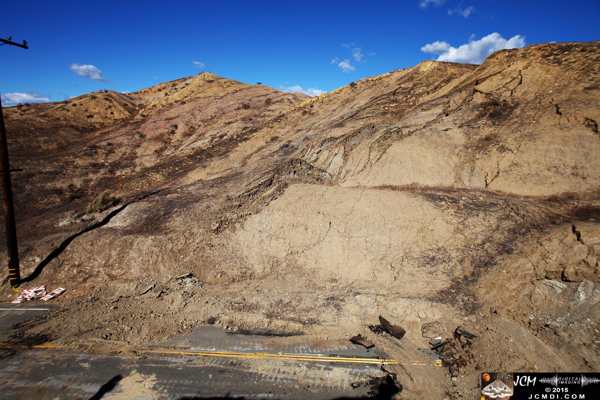 Landslide, buckled pavement, and terrain at Vasquez Canyon Road in Santa Clarita, CA filmed 11-25-2015